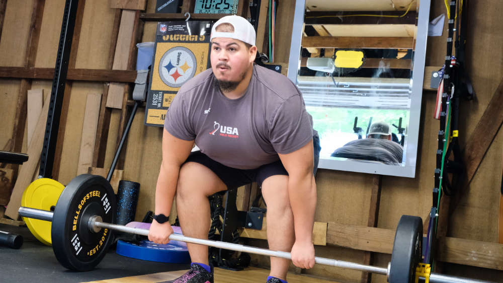 One of our trainers performing a barbell deadlift workout