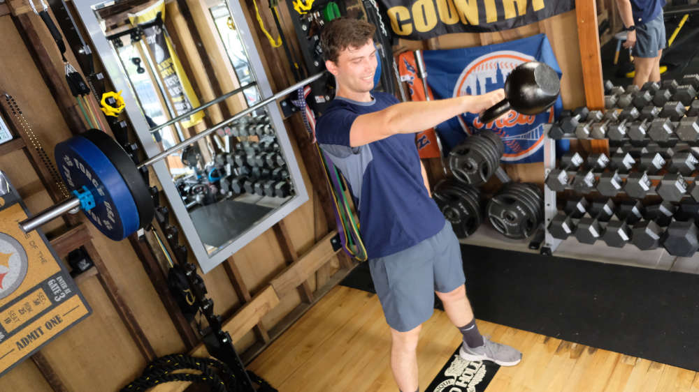 One of our trainers performing a kettlebell swing workout